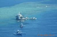 Aerial shot of BFAR vessel BRP Datu Magat Salamat distributing goods to Filipino fishermen in the West Philippine Sea.