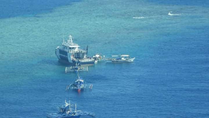 Aerial shot of BFAR vessel BRP Datu Magat Salamat distributing goods to Filipino fishermen in the West Philippine Sea.