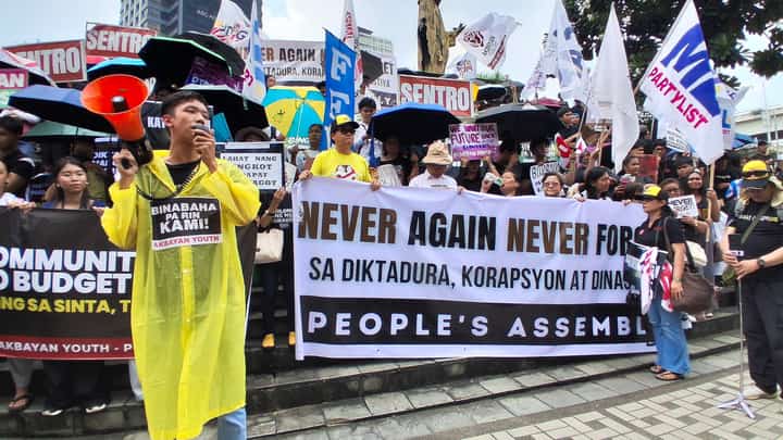 A third-year Social Science Education student from Bulacan State University (BulSU) holds a megaphone, speaking on behalf of his fellow students during the People’s Assembly program on the eve of the Martial Law anniversary at the EDSA Shrine in Quezon City on 20 September 2026.