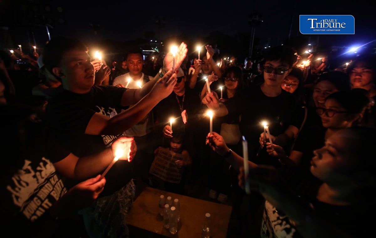 (September 20 2026) Tindig Kalumpitenyo group hold a lightning candle as a symbol of their visual expression of anger over the flood-control controversy and the continuing demand for accountability, and to honor those who lost their lives due to the flood. during the Tindig Kalumpitenyo a Black, Mud, and Candles, interfaith prayer rally, on Sunday September 20 2026/Analy Labor
