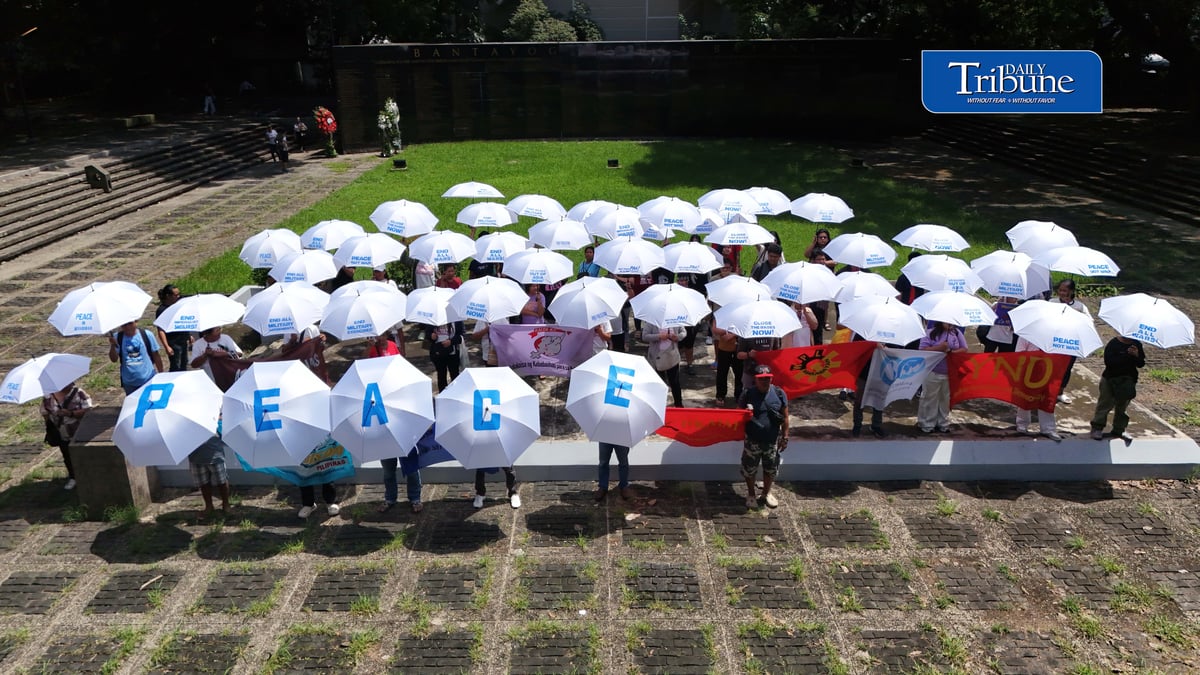 (September 21 2026) In observance of International Day of Peace, a global holiday observed every year on September 21 to commit to peace and stop all violence, and also 54th anniversary of the declaration of Martial Law. Members of Kilusan para sa Pambansang Demokrasya and World BEYOND War Asia hold dozens of white umbrellas symbolizing their call for peace, opposition to Pax Silica, rejection of US-Philippine military agreements, support for a Free Palestine, peace in Myanmar, and the call for “US Out of Asia” during a protest action dubbed PEACE Umbrellas: Shield to Continuous Rain of War and Militarism, at the Bantayog ng mga Bayani in Quezon City on Monday, September 21, 2026. Photo/Analy Labor