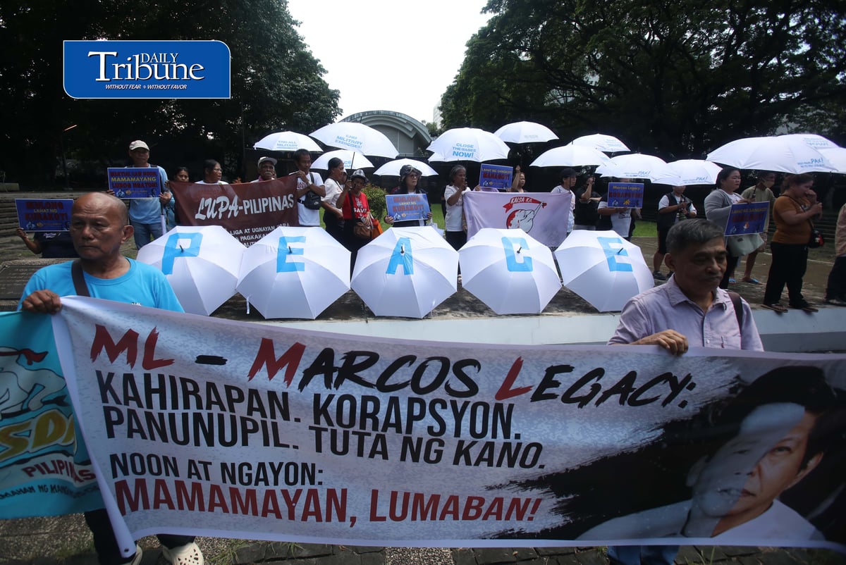 (September 21 2026) In observance of International Day of Peace, a global holiday observed every year on September 21 to commit to peace and stop all violence, and also 54th anniversary of the declaration of Martial Law. Members of Kilusan para sa Pambansang Demokrasya and World BEYOND War Asia hold dozens of white umbrellas symbolizing their call for peace, opposition to Pax Silica, rejection of US-Philippine military agreements, support for a Free Palestine, peace in Myanmar, and the call for “US Out of Asia” during a protest action dubbed PEACE Umbrellas: Shield to Continuous Rain of War and Militarism, at the Bantayog ng mga Bayani in Quezon City on Monday, September 21, 2026. Photo/Analy Labor