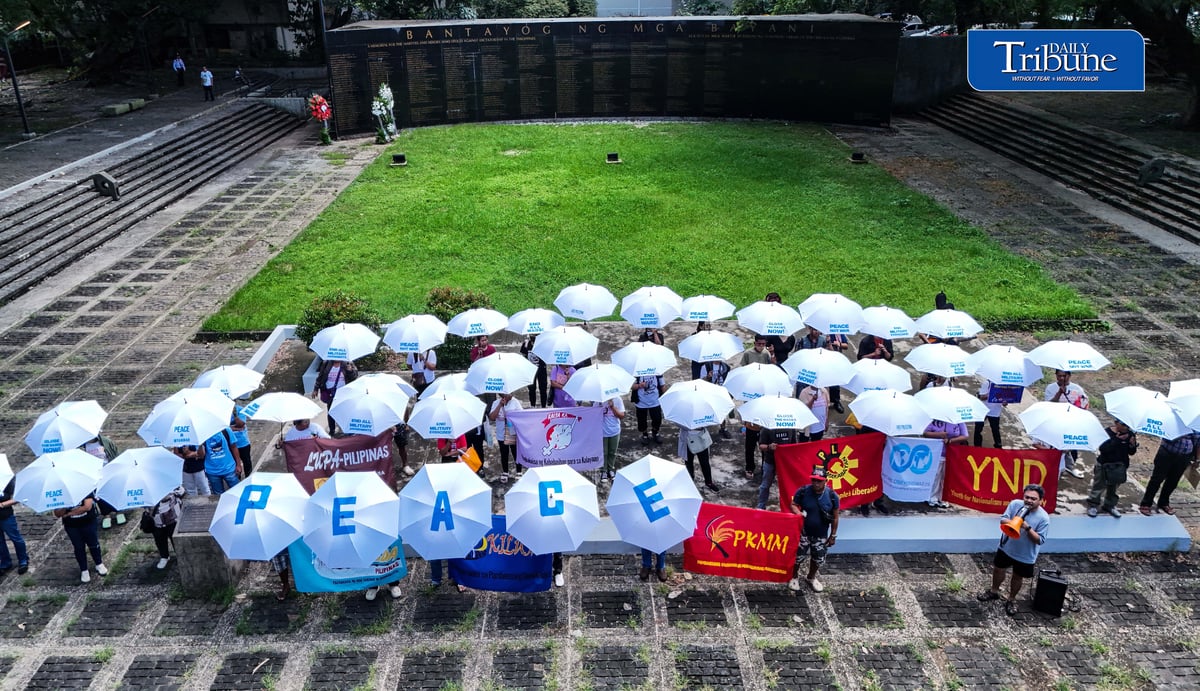 (September 21 2026) In observance of International Day of Peace, a global holiday observed every year on September 21 to commit to peace and stop all violence, and also 54th anniversary of the declaration of Martial Law. Members of Kilusan para sa Pambansang Demokrasya and World BEYOND War Asia hold dozens of white umbrellas symbolizing their call for peace, opposition to Pax Silica, rejection of US-Philippine military agreements, support for a Free Palestine, peace in Myanmar, and the call for “US Out of Asia” during a protest action dubbed PEACE Umbrellas: Shield to Continuous Rain of War and Militarism, at the Bantayog ng mga Bayani in Quezon City on Monday, September 21, 2026. Photo/Analy Labor