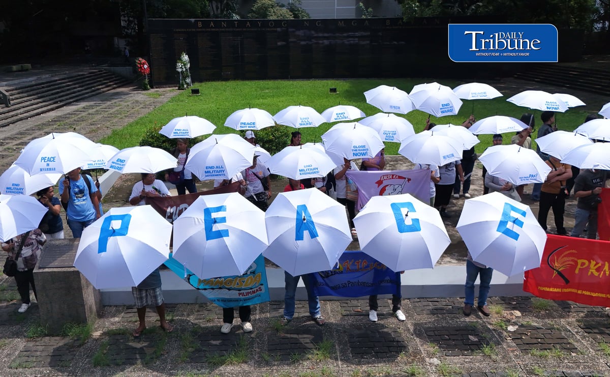 (September 21 2026) In observance of International Day of Peace, a global holiday observed every year on September 21 to commit to peace and stop all violence, and also 54th anniversary of the declaration of Martial Law. Members of Kilusan para sa Pambansang Demokrasya and World BEYOND War Asia hold dozens of white umbrellas symbolizing their call for peace, opposition to Pax Silica, rejection of US-Philippine military agreements, support for a Free Palestine, peace in Myanmar, and the call for “US Out of Asia” during a protest action dubbed PEACE Umbrellas: Shield to Continuous Rain of War and Militarism, at the Bantayog ng mga Bayani in Quezon City on Monday, September 21, 2026. Photo/Analy Labor