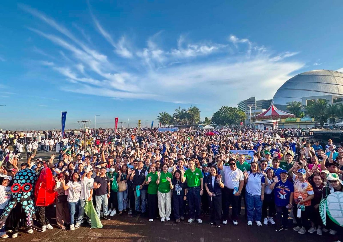VOLUNTEERS gather along the SM by the Bay shoreline on 19 September as part of SM Cares’ annual coastal cleanup, promoting collective action for cleaner shores.