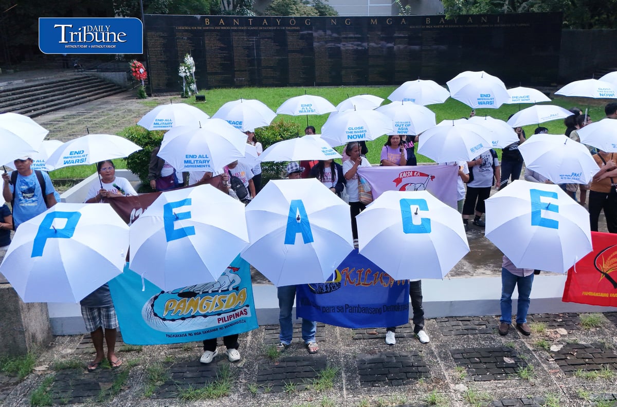 (September 21 2026) In observance of International Day of Peace, a global holiday observed every year on September 21 to commit to peace and stop all violence, and also 54th anniversary of the declaration of Martial Law. Members of Kilusan para sa Pambansang Demokrasya and World BEYOND War Asia hold dozens of white umbrellas symbolizing their call for peace, opposition to Pax Silica, rejection of US-Philippine military agreements, support for a Free Palestine, peace in Myanmar, and the call for “US Out of Asia” during a protest action dubbed PEACE Umbrellas: Shield to Continuous Rain of War and Militarism, at the Bantayog ng mga Bayani in Quezon City on Monday, September 21, 2026. Photo/Analy Labor