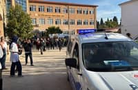 THIS handout photograph taken and released by Demiroren News Agency shows ambulances and police officers waiting in front of a high school outside which a gunman opened fire wounding eight people, and was detained shortly afterwards, in Turgutlu, an area west of the resort city of Izmir.