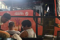 Passengers wait for scheduled departure in a bus terminal