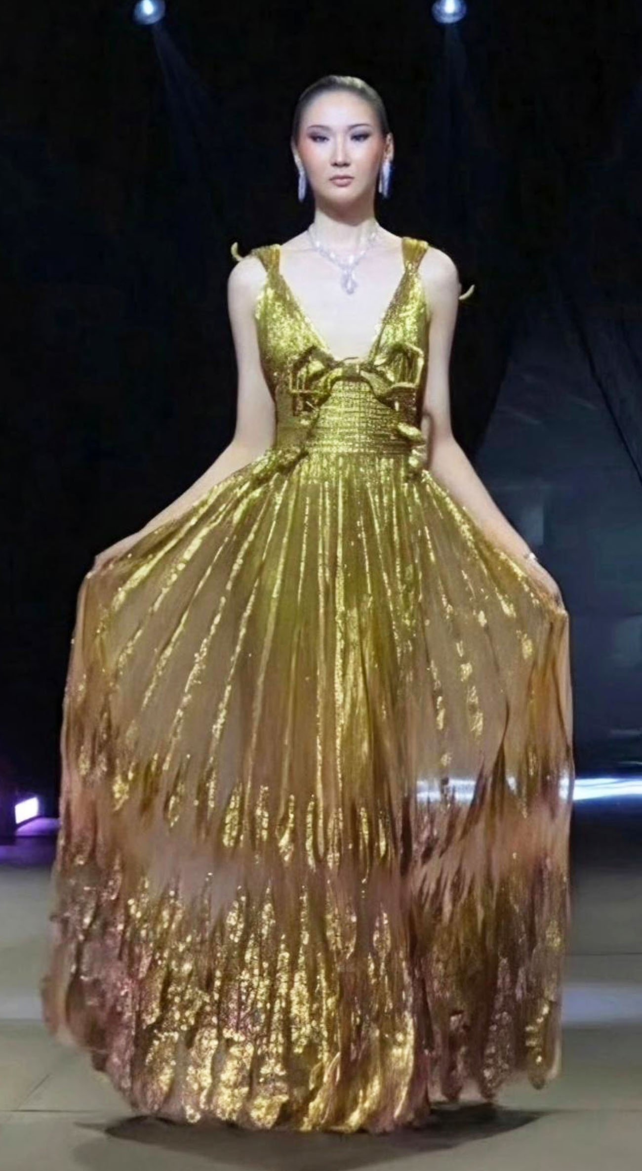 DAZZLING gold couture with sculpted bodice and delicate shoulder straps.