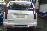 QUEZON City Police District Anti-Carnapping Unit operatives present the recovered 2024 Mitsubishi Montero SUV outside their headquarters.