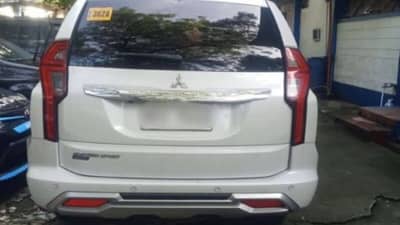 QUEZON City Police District Anti-Carnapping Unit operatives present the recovered 2024 Mitsubishi Montero SUV outside their headquarters.