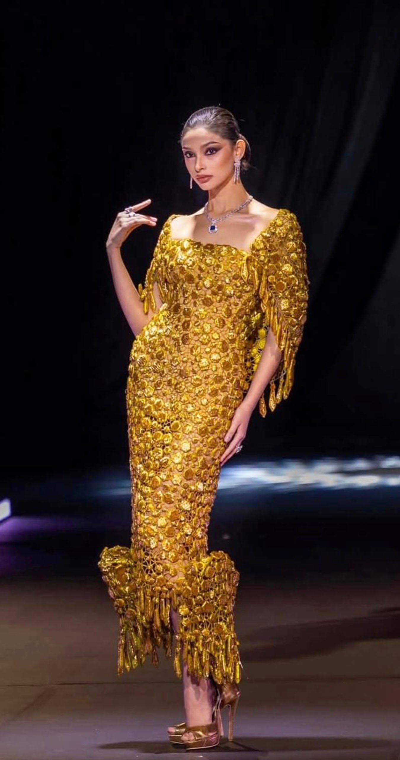 A stunning gold gown adorned with embellishments.