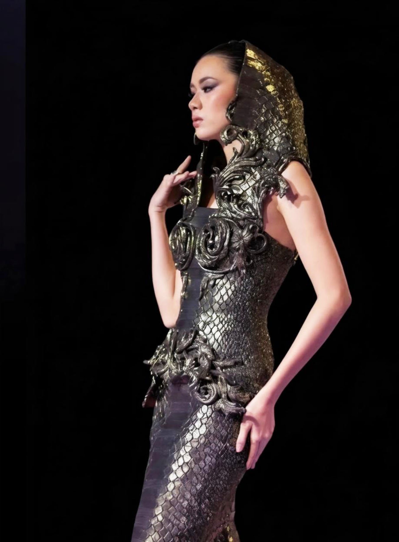 A bold metallic gown with intricate scale-like detailing.