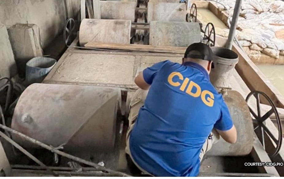 CIDG personnel inspect seized mining equipment and materials in Barangay Bulo, Buenavista, Quezon.
