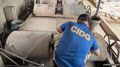 CIDG personnel inspect seized mining equipment and materials in Barangay Bulo, Buenavista, Quezon.