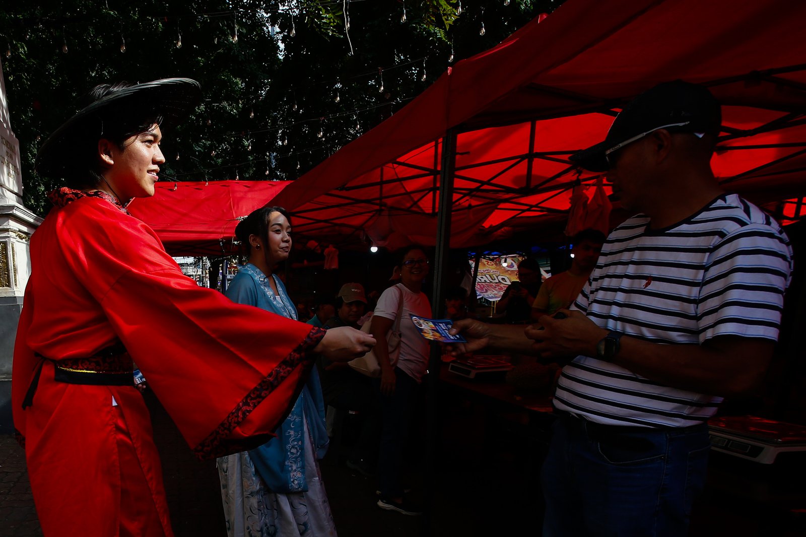 Dressed in traditional Chinese costumes, Hairo Oliquino and Janelle Buesing roam around Plaza Calderon dela Barca in Binondo, Manila, on 26 September 2026, to promote the latest food destination in Chinatown. Binondo is known for its vibrant Chinese food culture and diverse culinary offerings.