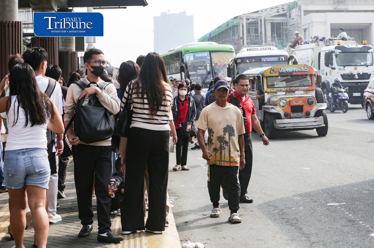Commuters wait for public transportation at Philcoa along Commonwealth Avenue in Quezon City on Monday, 28 September 2026, amid a transport strike. | Analy Labor