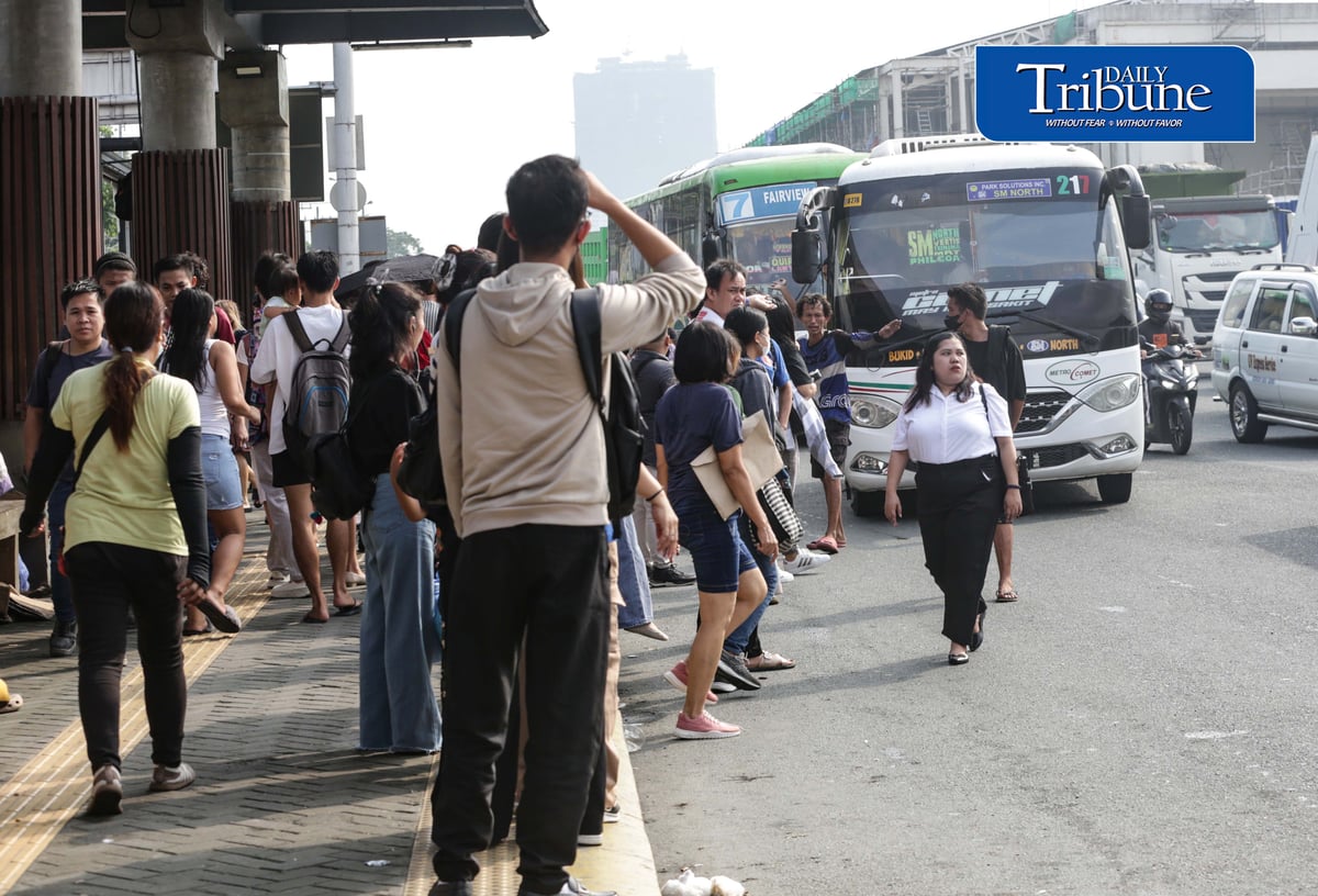Commuters wait for public transportation at Philcoa along Commonwealth Avenue in Quezon City on Monday, 28 September 2026, amid a transport strike. | Analy Labor