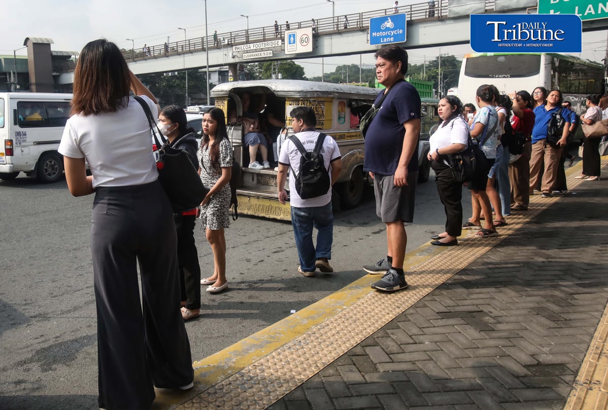 Commuters wait for public transportation at Philcoa along Commonwealth Avenue in Quezon City on Monday, 28 September 2026, amid a transport strike. | Analy Labor