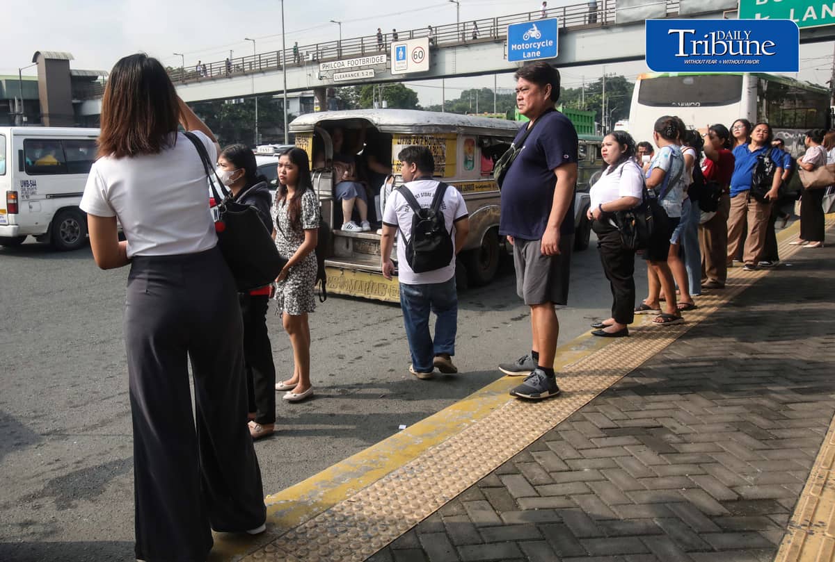 Commuters wait for public transportation at Philcoa along Commonwealth Avenue in Quezon City on Monday, 28 September 2026, amid a transport strike. | Analy Labor