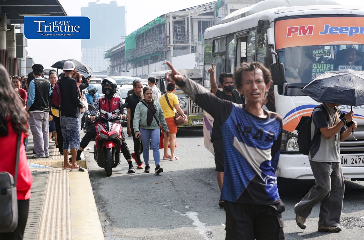 Commuters wait for public transportation at Philcoa along Commonwealth Avenue in Quezon City on Monday, 28 September 2026, amid a transport strike. | Analy Labor
