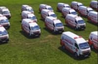 A fleet of white and red ambulances lined up on a field for Laguna’s Ambulance on the Go emergency response program.