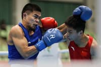 CARLO PAALAM (left) punches his way to the medal round following a 3-2 2 win over Zhang Jiamao of China in their 55-kilogram quarterfinal duel on Monday at the Nishio Gym in Nagoya.