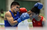 CARLO PAALAM (left) punches his way to the medal round following a 3-2 2 win over Zhang Jiamao of China in their 55-kilogram quarterfinal duel on Monday at the Nishio Gym in Nagoya.