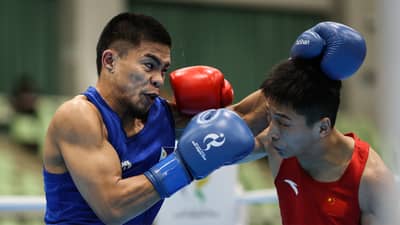 CARLO PAALAM (left) punches his way to the medal round following a 3-2 2 win over Zhang Jiamao of China in their 55-kilogram quarterfinal duel on Monday at the Nishio Gym in Nagoya.