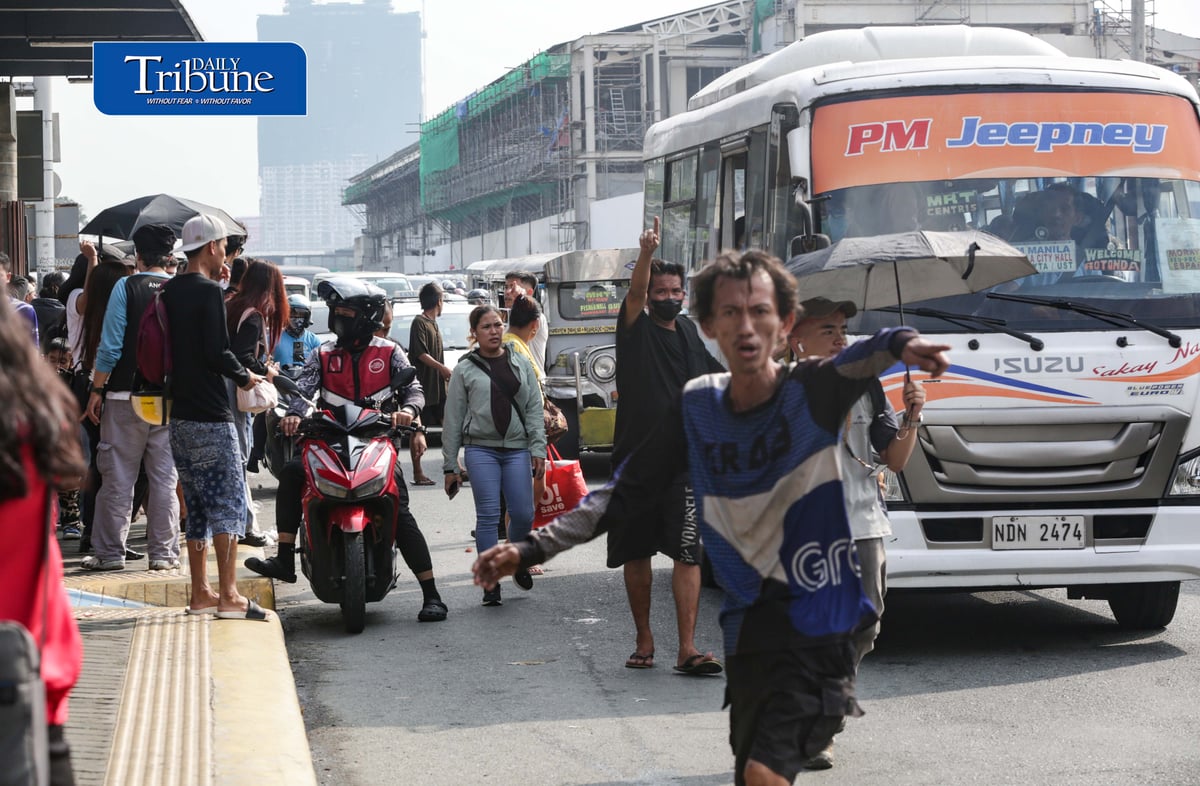 Commuters wait for public transportation at Philcoa along Commonwealth Avenue in Quezon City on Monday, 28 September 2026, amid a transport strike. | Analy Labor