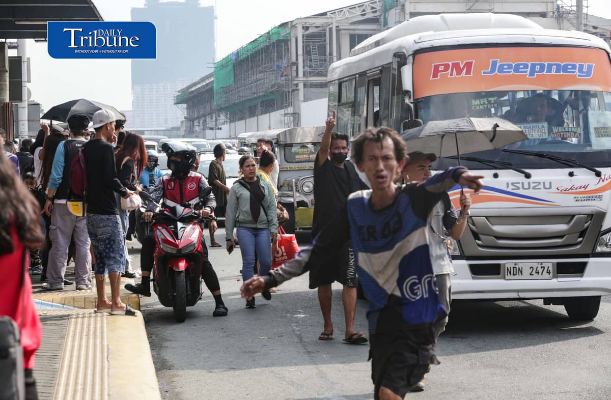 Commuters wait for public transportation at Philcoa along Commonwealth Avenue in Quezon City on Monday, 28 September 2026, amid a transport strike. | Analy Labor