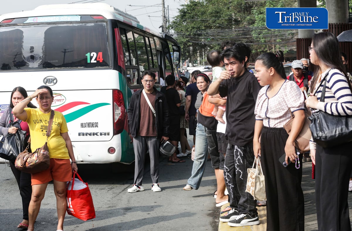Commuters wait for public transportation at Philcoa along Commonwealth Avenue in Quezon City on Monday, 28 September 2026, amid a transport strike. | Analy Labor