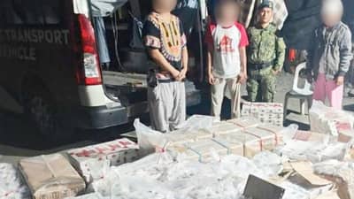 POLICE officers inspect master cases of alleged smuggled cigarettes valued at P1.08 million following a highway checkpoint operation in Kapatagan, Lanao del Norte, on Tuesday.