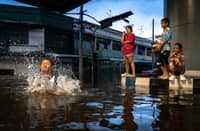 CHILDREN play in floodwaters in Bangkok’s Bang Kapi district.