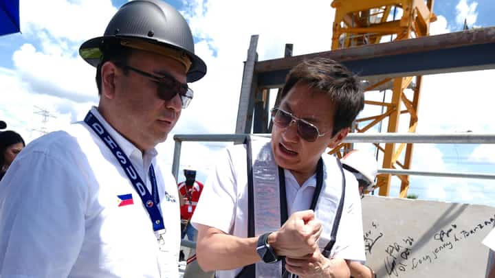 HOUSING Secretary Jose Ramon P. Aliling (left) and Megawide chairman Edgar Saavedra (right) attend the topping-off ceremony of Towers C and D of Jab Residences in Dasmariñas, Cavite.