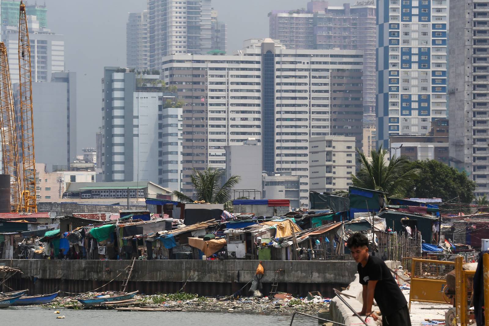 Makeshift homes stand in contrast with high-rise buildings in Manila, in this photo taken on 02 October 2026. The scene comes as the national government’s outstanding debt reached ₱19.39 trillion as of July 2026, according to the Bureau of the Treasury.