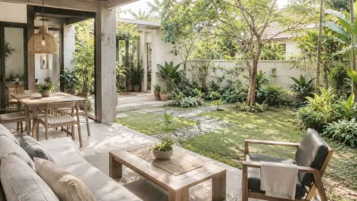 LARGE windows and greenery connect the interior of a contemporary Filipino home with its outdoor surroundings while allowing natural light