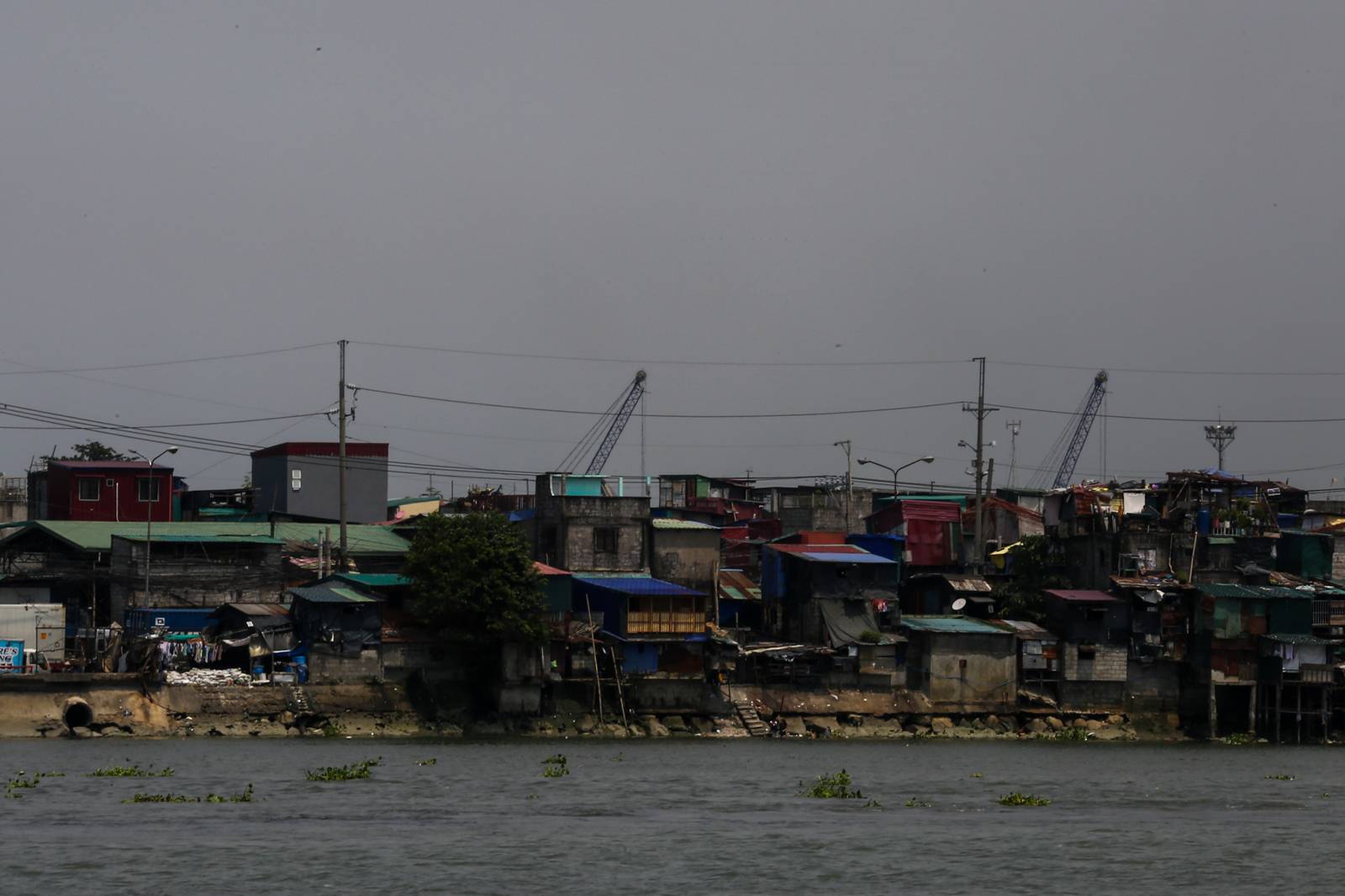 Informal settlements line the Pasig River in Manila on 02 October 2026. The communities face increased exposure to extreme heat as El Niño is expected to intensify, with a Climate Impact Lab study projecting about 6,500 excess heat-related deaths in the Philippines from June 2026 to February 2027 as temperatures rise above historical averages.