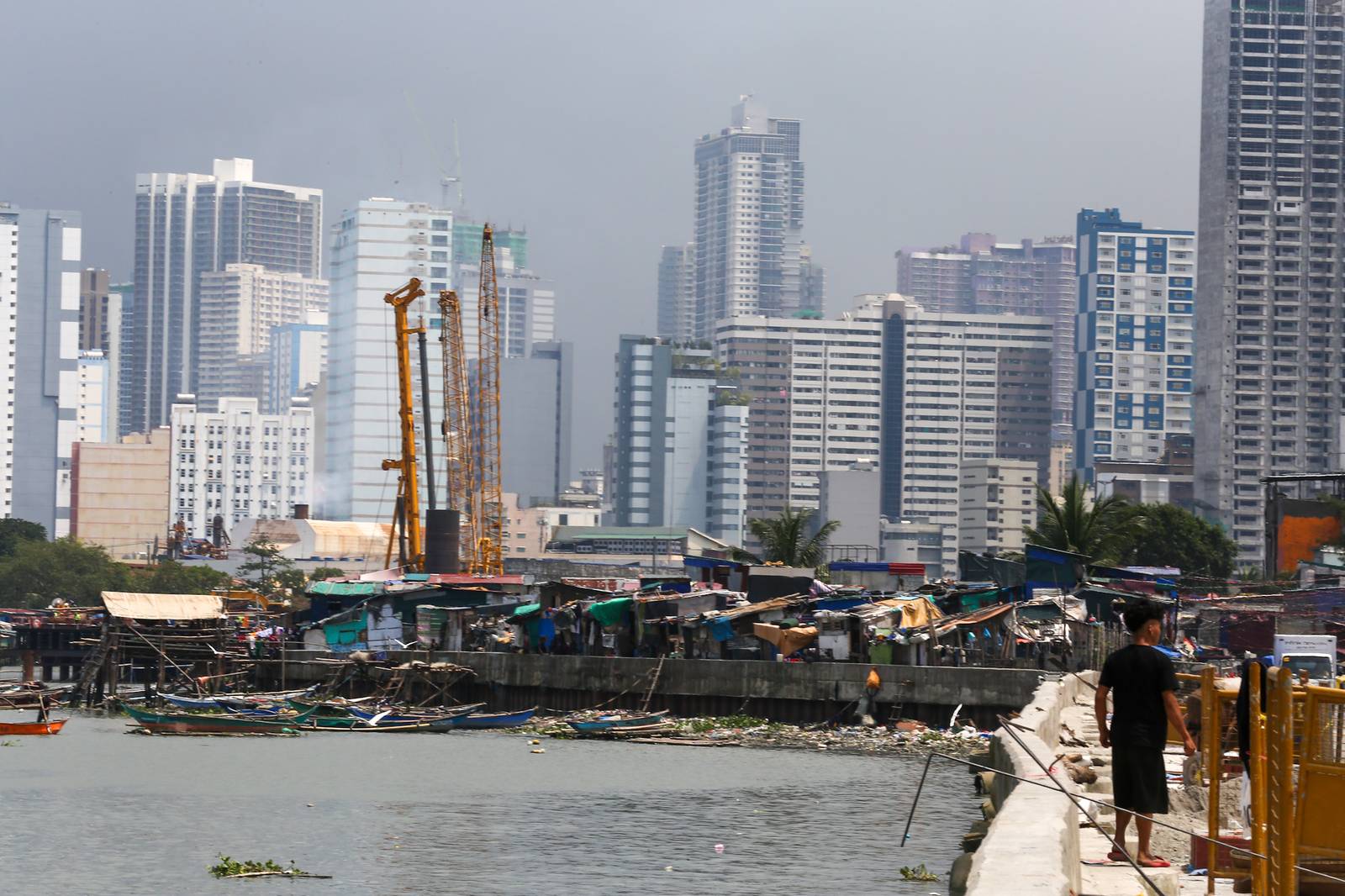 Makeshift homes stand in contrast with high-rise buildings in Manila, in this photo taken on 02 October 2026. The scene comes as the national government’s outstanding debt reached ₱19.39 trillion as of July 2026, according to the Bureau of the Treasury.