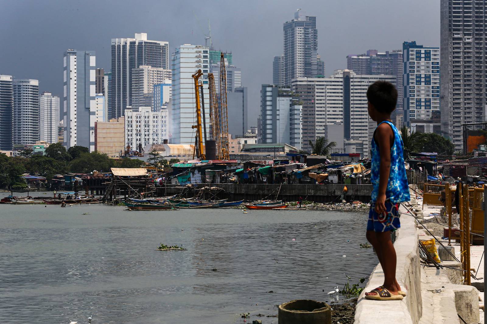 Makeshift homes stand in contrast with high-rise buildings in Manila, in this photo taken on 02 October 2026. The scene comes as the national government’s outstanding debt reached ₱19.39 trillion as of July 2026, according to the Bureau of the Treasury.