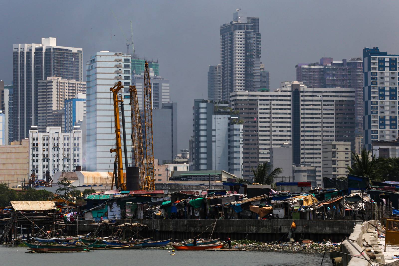 Makeshift homes stand in contrast with high-rise buildings in Manila, in this photo taken on 02 October 2026. The scene comes as the national government’s outstanding debt reached ₱19.39 trillion as of July 2026, according to the Bureau of the Treasury.