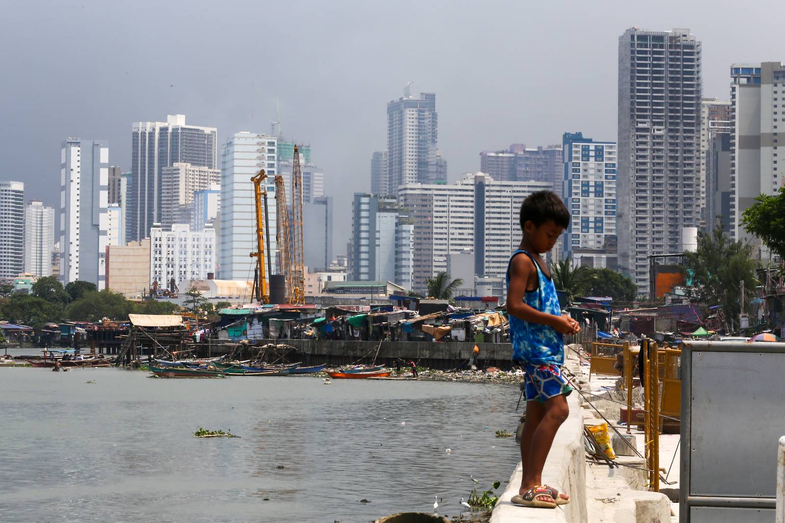 Makeshift homes stand in contrast with high-rise buildings in Manila, in this photo taken on 02 October 2026. The scene comes as the national government’s outstanding debt reached ₱19.39 trillion as of July 2026, according to the Bureau of the Treasury.