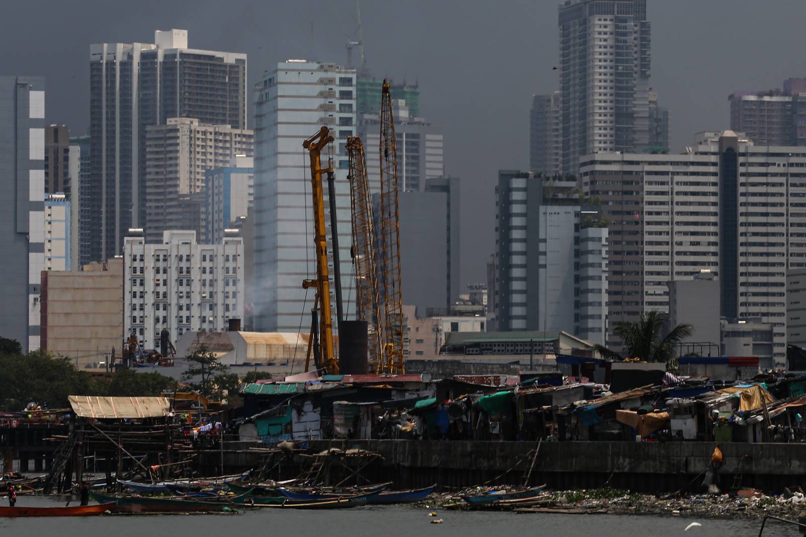 Makeshift homes stand in contrast with high-rise buildings in Manila, in this photo taken on 02 October 2026. The scene comes as the national government’s outstanding debt reached ₱19.39 trillion as of July 2026, according to the Bureau of the Treasury.