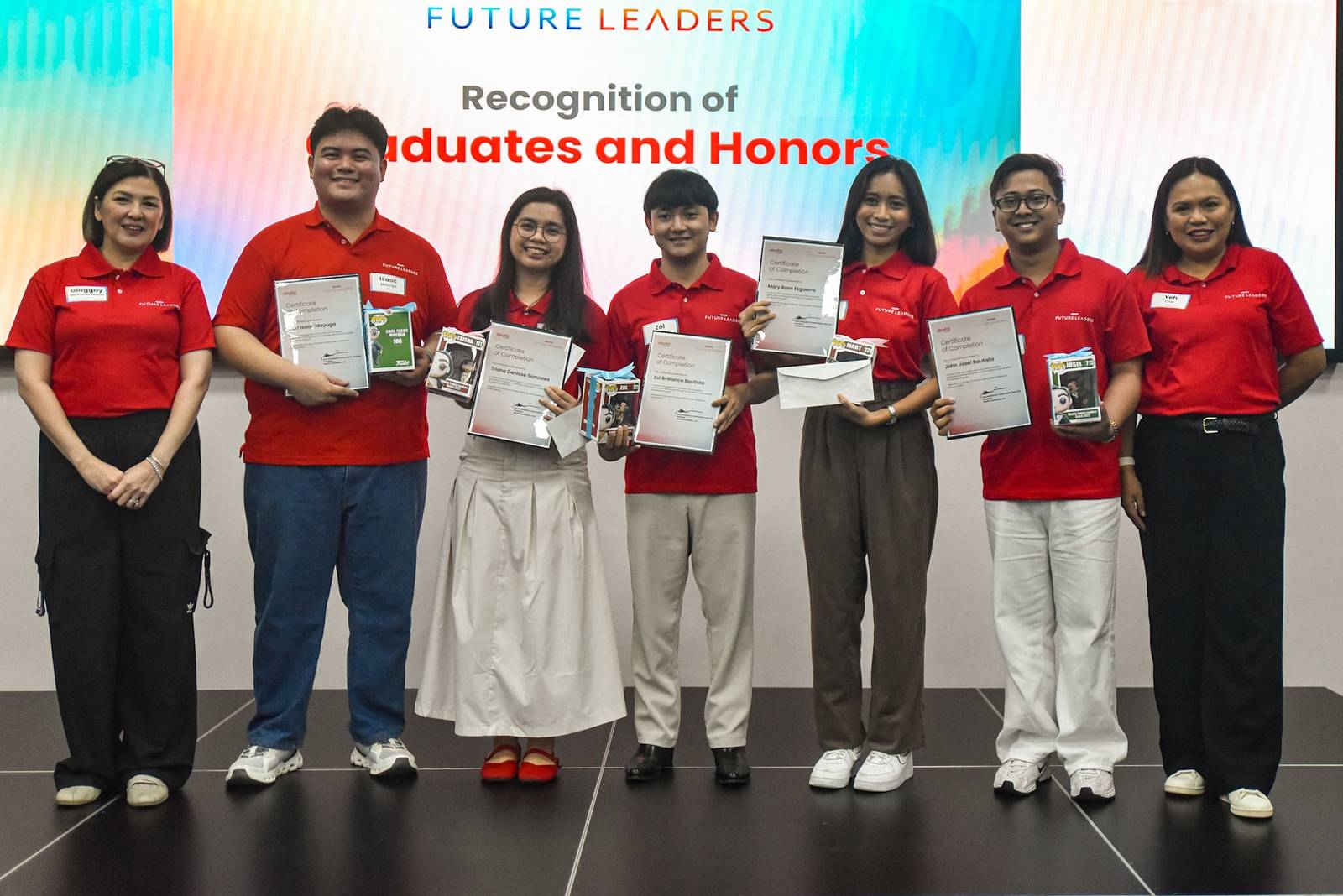 ABOITIZ Foundation president Ginggay Hontiveros-Malvar (left) and impact lead for education Jowelle Ann Cruz (right) with 2026 scholarship graduates with honors.