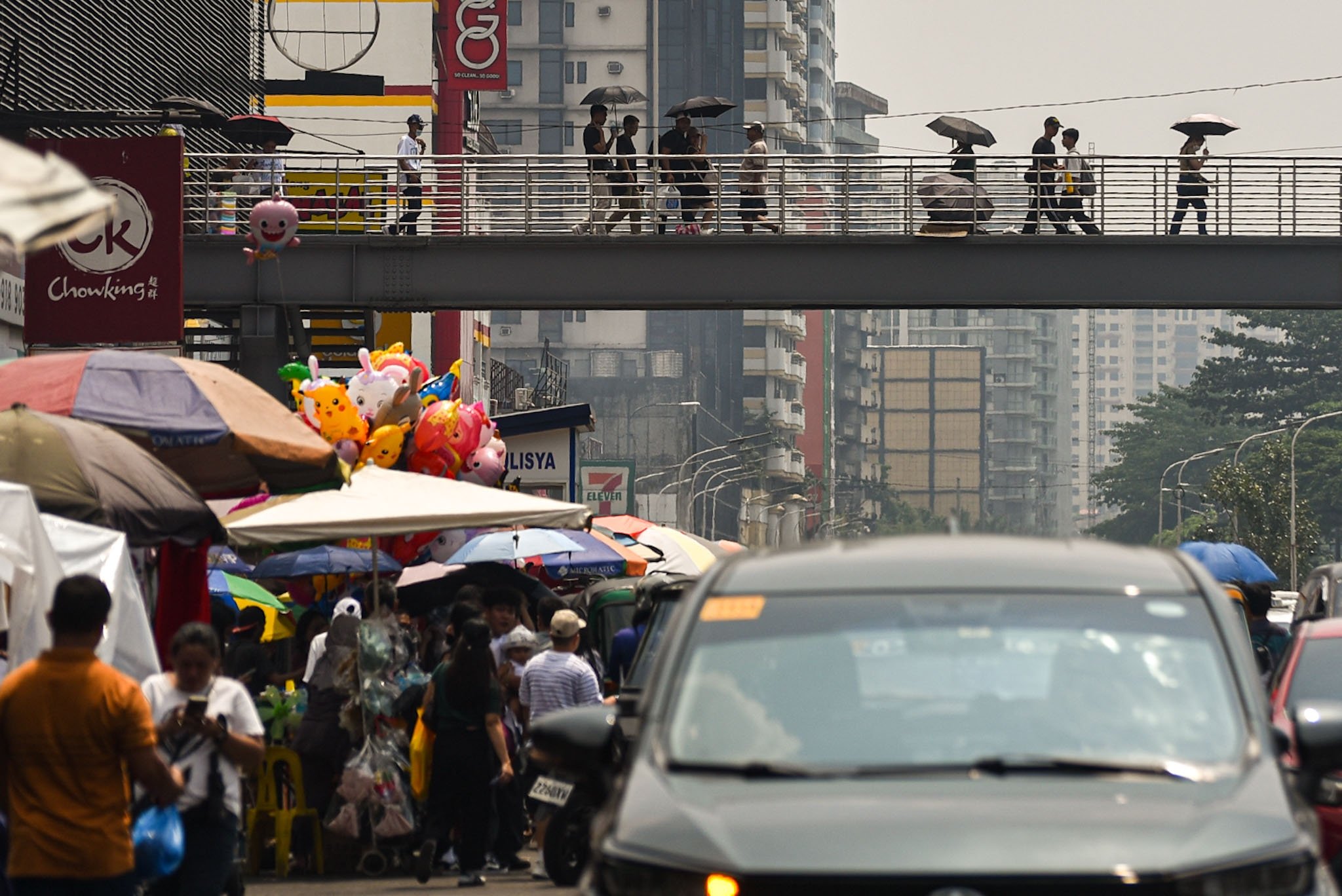 Pedestrians walk through an overpass despite the Sunny weather in Parañeque