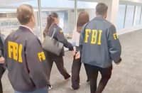FEDERAL Bureau of Investigation agents accost Wanying Zhang (2nd from right) who was arrested at the Los Angeles airport in California.