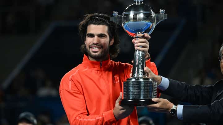 Spain's Carlos Alcaraz holds the trophy as he celebrates beating Czech Republic's Jiri Lehecka in the men's singles final during the Japan Open tennis tournament at the Ariake Tennis Forest Park in Tokyo on October 6, 2026.