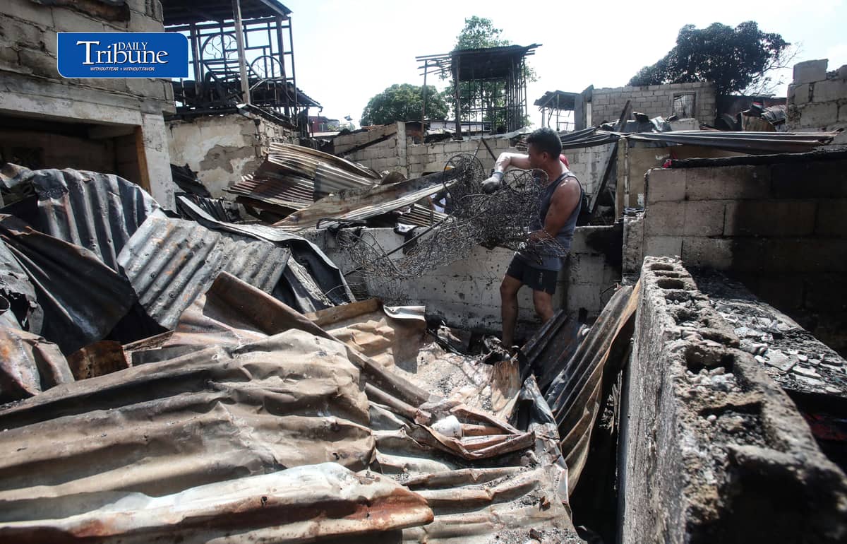 (October 07 2026) Fire victims at Waling Waling, in Brgy. Central, Quezon City on Wednesday October 7 2026, savage reusable materials lifted from the fifth alarm fire that hit in the area on Tuesday. Photo/Analy Labor