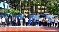 Four Muntinlupa City electric buses are displayed with city officials ahead of the start of the free e-bus service.