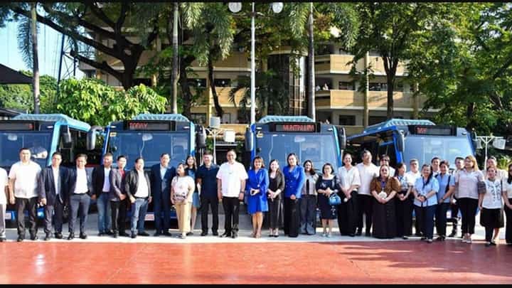 Four Muntinlupa City electric buses are displayed with city officials ahead of the start of the free e-bus service.
